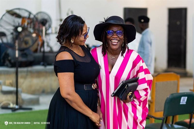 Two members of KMC smiling together after a service