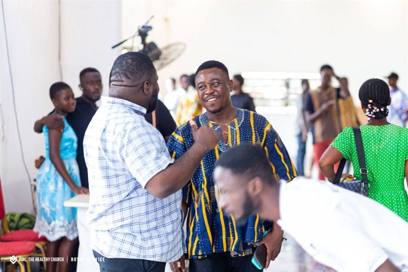 Members of KMC greeting one another warmly